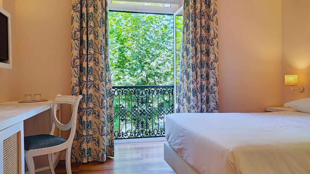 Uma cama ou camas num quarto em Grande Hotel das Caldas da Felgueira