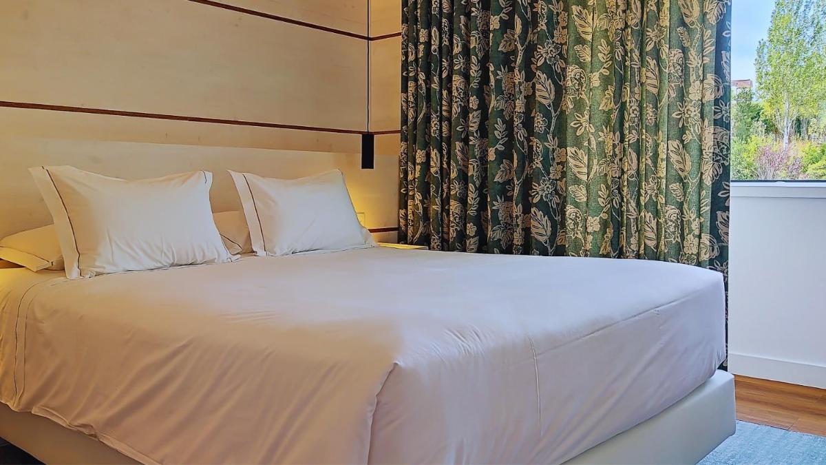 Uma cama ou camas num quarto em Grande Hotel das Caldas da Felgueira