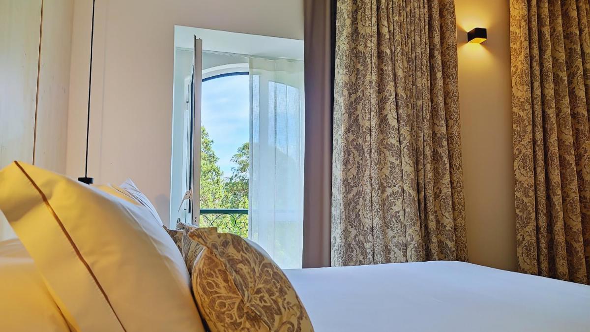 Uma cama ou camas num quarto em Grande Hotel das Caldas da Felgueira