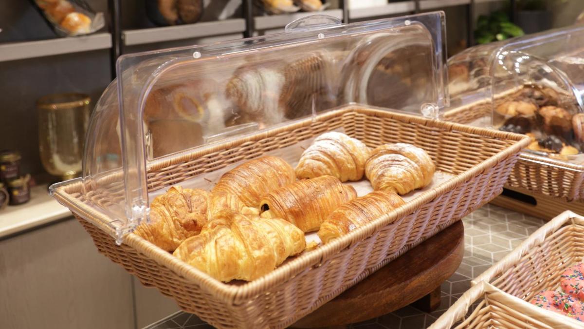 a bunch of pastries in baskets in a bakery at Crowne Plaza Today Gurugram by IHG in Gurgaon