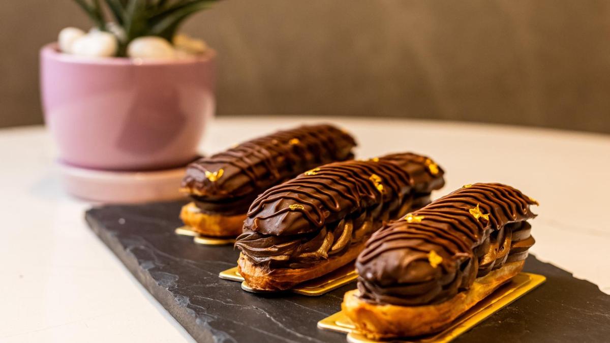 three chocolate covered donuts sitting on a table at Crowne Plaza Today Gurugram by IHG in Gurgaon