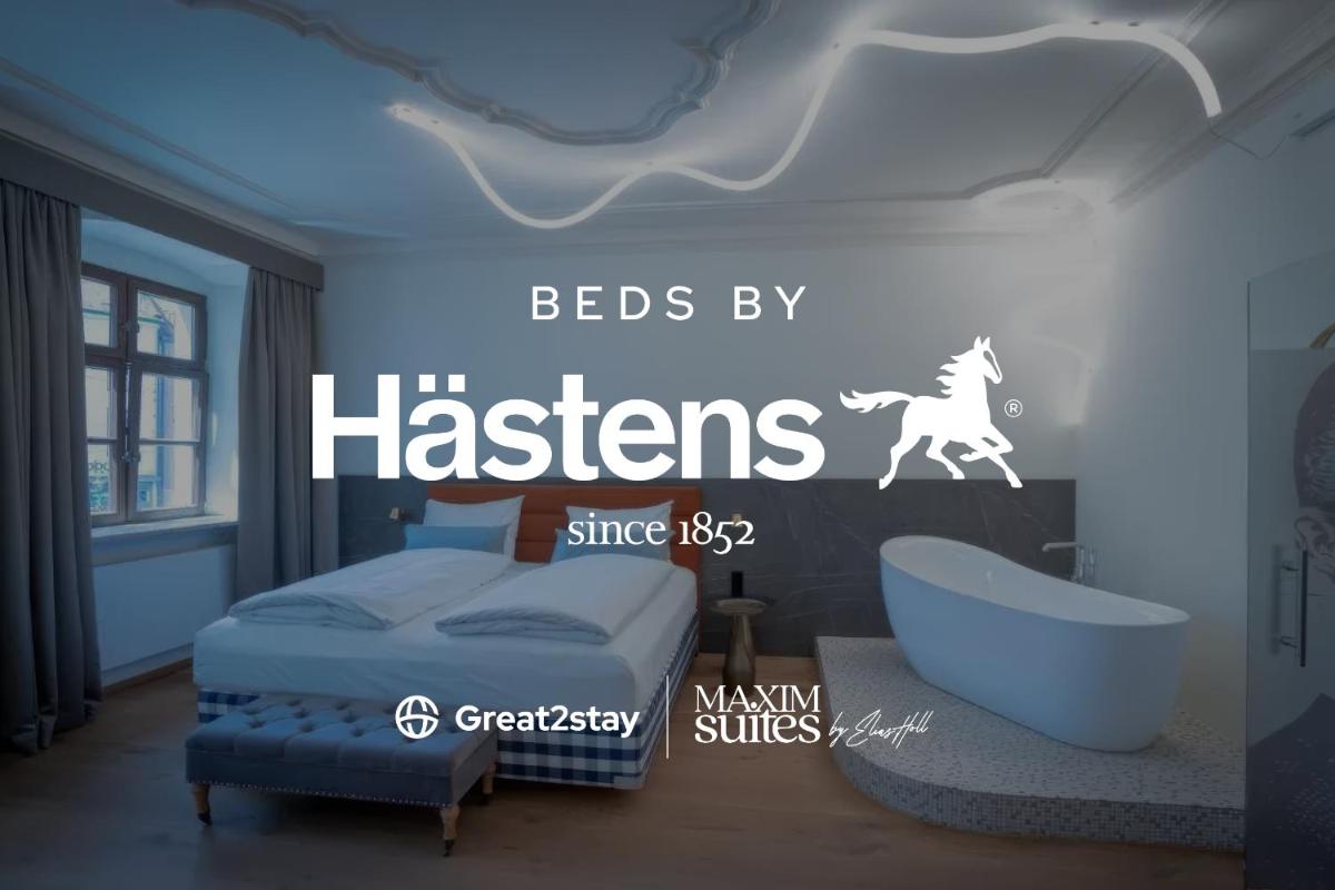 Ein Bett oder Betten in einem Zimmer der Unterkunft Maxim Suites by Elias Holl