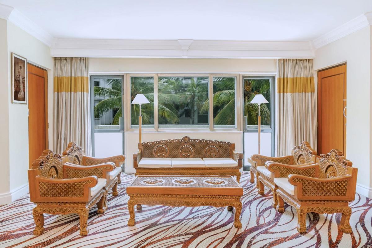 a living room with a couch and two chairs at Le Royal Meridien Chennai in Chennai
