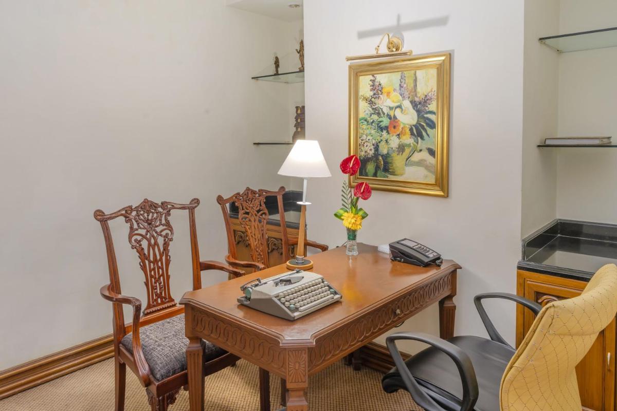 an office with a desk with a phone on it at Le Royal Meridien Chennai in Chennai