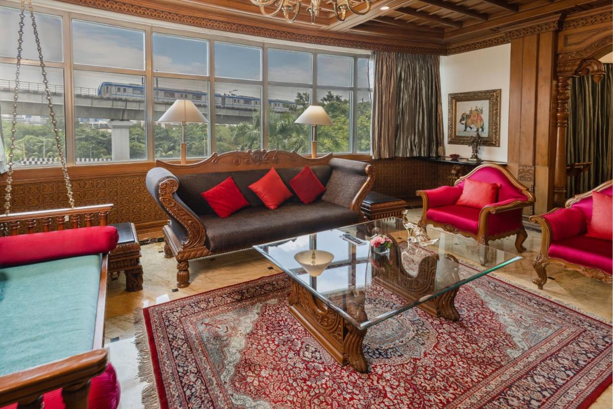 a living room with a couch and chairs and a table at Le Royal Meridien Chennai in Chennai