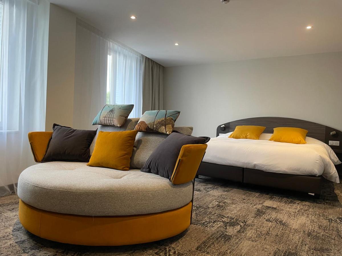Un ou plusieurs lits dans un hébergement de l'établissement Brit Hotel de Grignan Vichy
