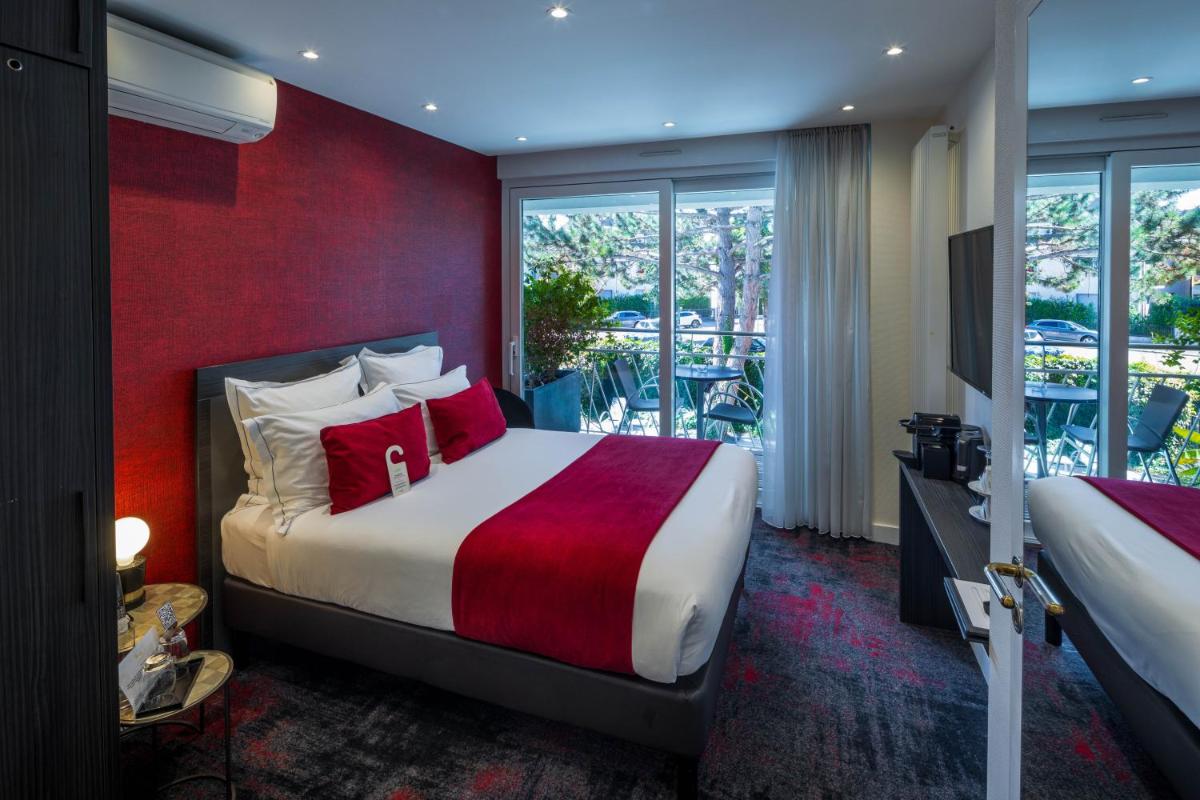 Un ou plusieurs lits dans un hébergement de l'établissement Hôtel Villa La Florangerie - SPA & Piscine