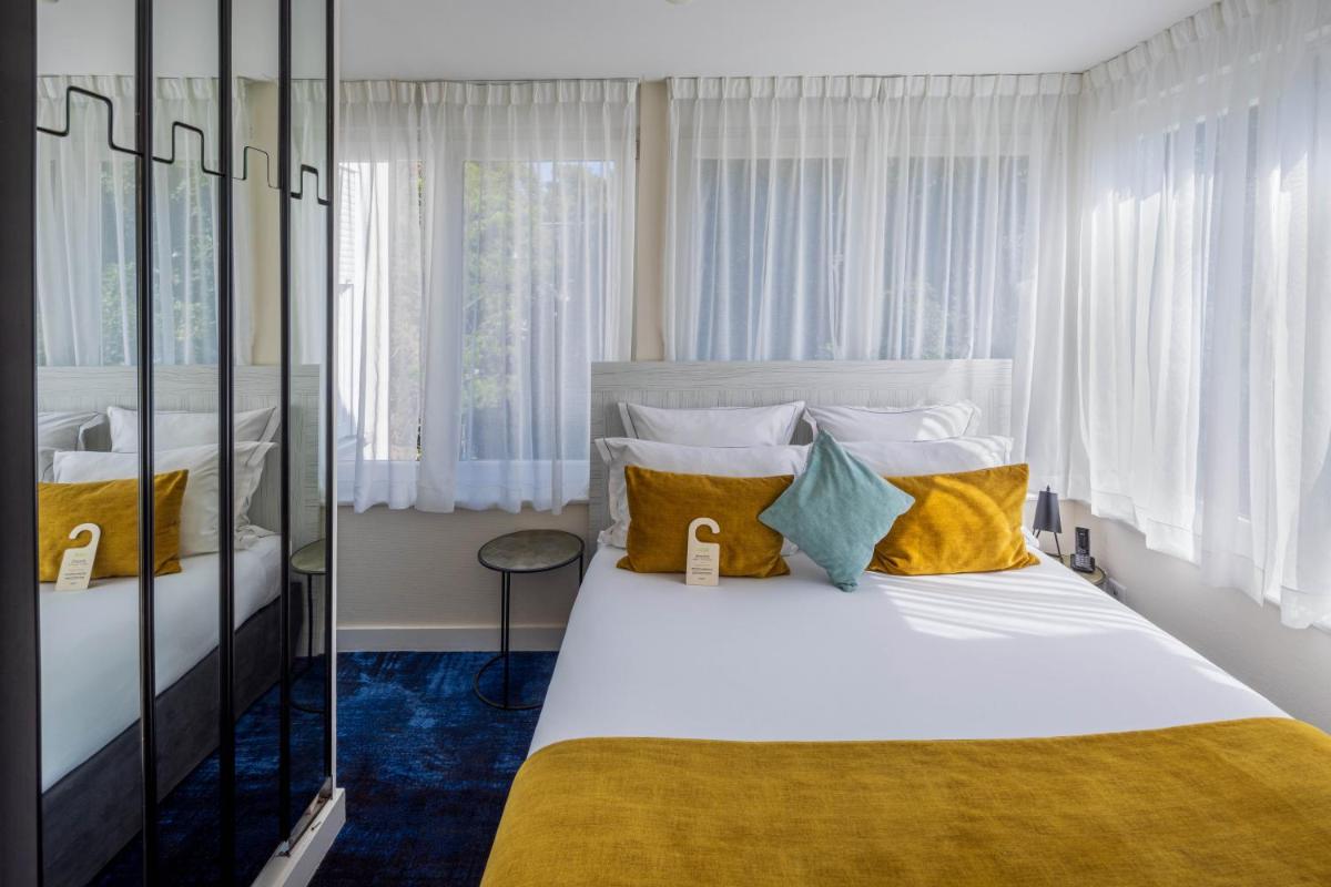 Un ou plusieurs lits dans un hébergement de l'établissement Hôtel Villa La Florangerie - SPA & Piscine