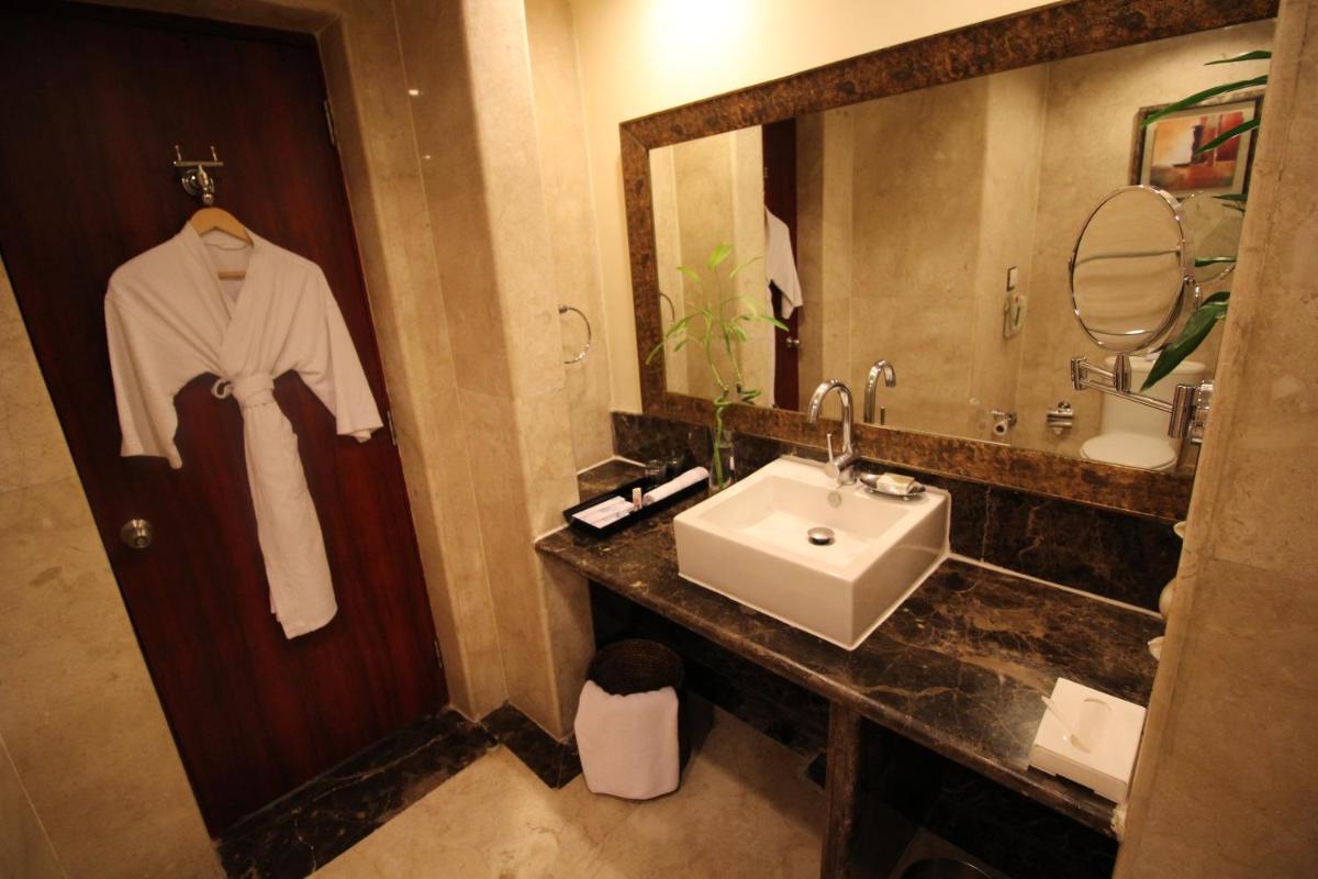 a bathroom with a sink and a mirror at Fortune Select JP Cosmos, Bengaluru - Member ITC Hotels' Group in Bengaluru