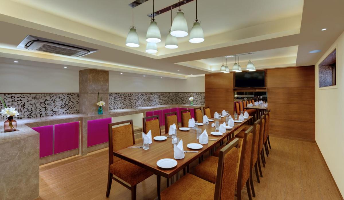 a dining room with a long table and chairs at The Fern Kadamba Hotel And Spa in Old Goa