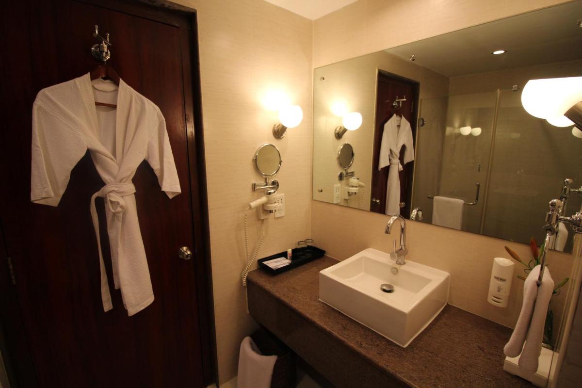 a hotel bathroom with a sink and a mirror at Fortune Select JP Cosmos, Bengaluru - Member ITC Hotels' Group in Bengaluru