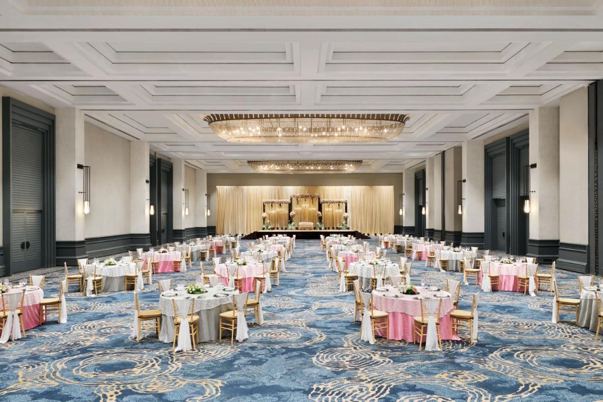 a banquet hall with white tables and chairs at The Westin Mumbai Powai Lake in Mumbai