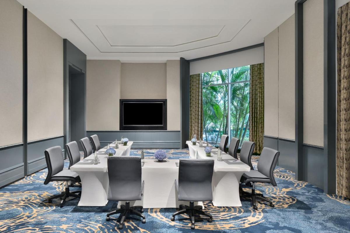 a conference room with a long table and chairs at The Westin Mumbai Powai Lake in Mumbai