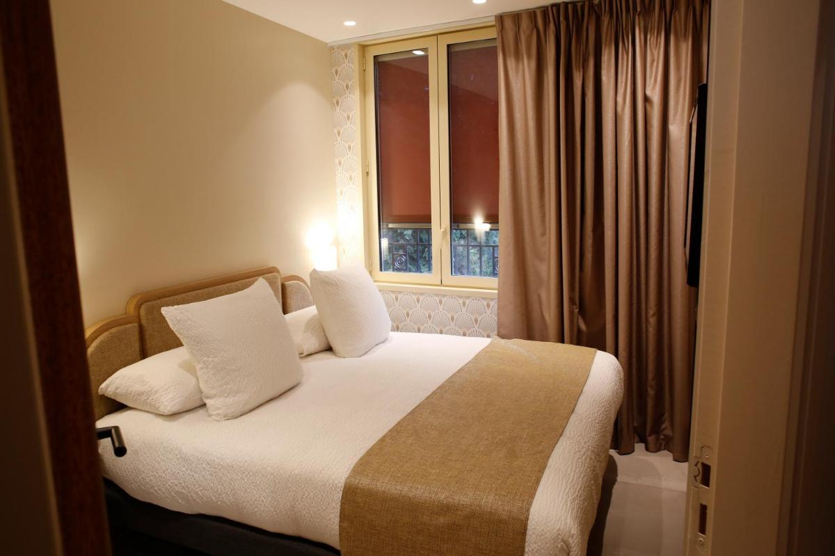Un ou plusieurs lits dans un hébergement de l'établissement Splendid Hôtel & Spa