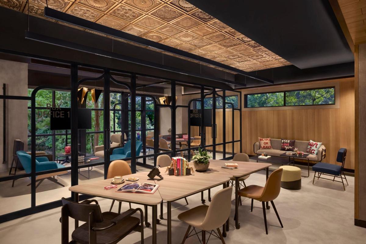 a dining room with a table and chairs at Moxy Mumbai Andheri West in Mumbai