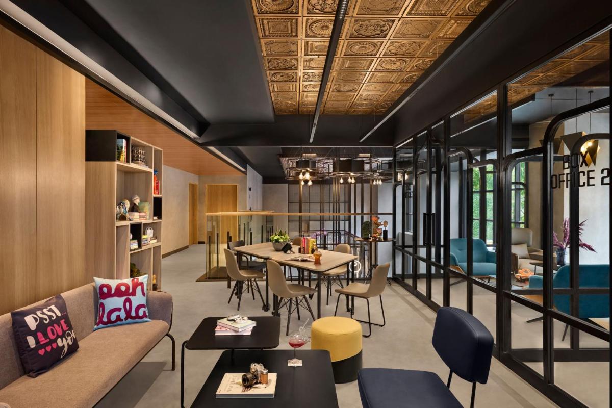 a living room with a couch and a table at Moxy Mumbai Andheri West in Mumbai