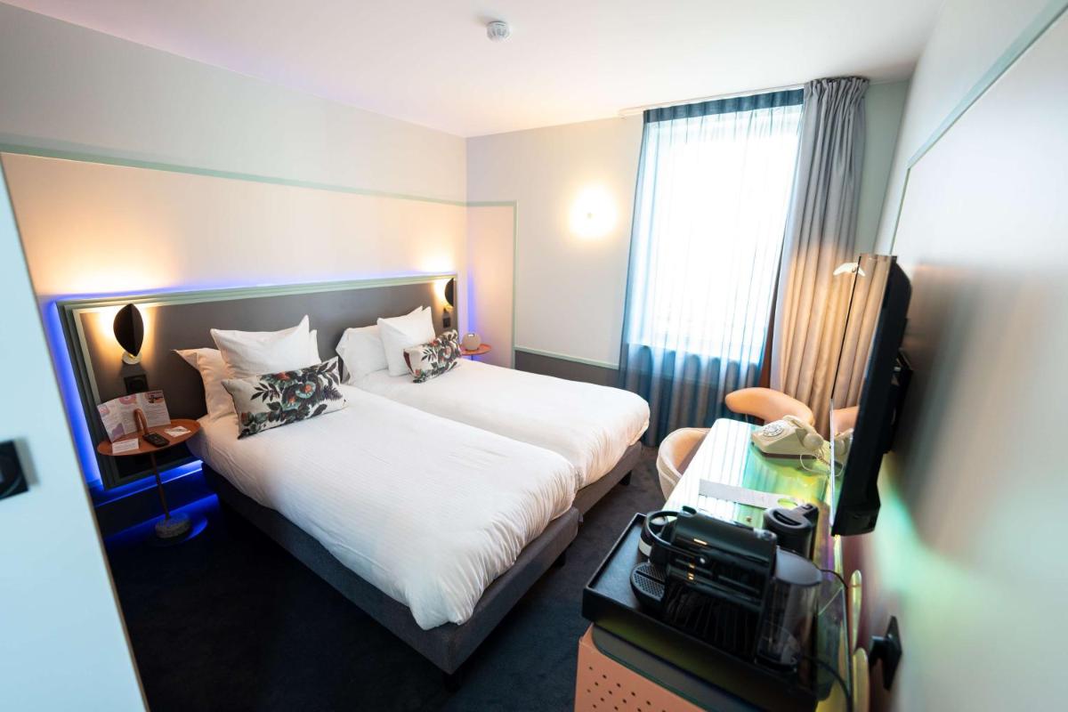 Un ou plusieurs lits dans un hébergement de l'établissement Aiden by Best Western Clermont-Ferrand Hotel & Spa