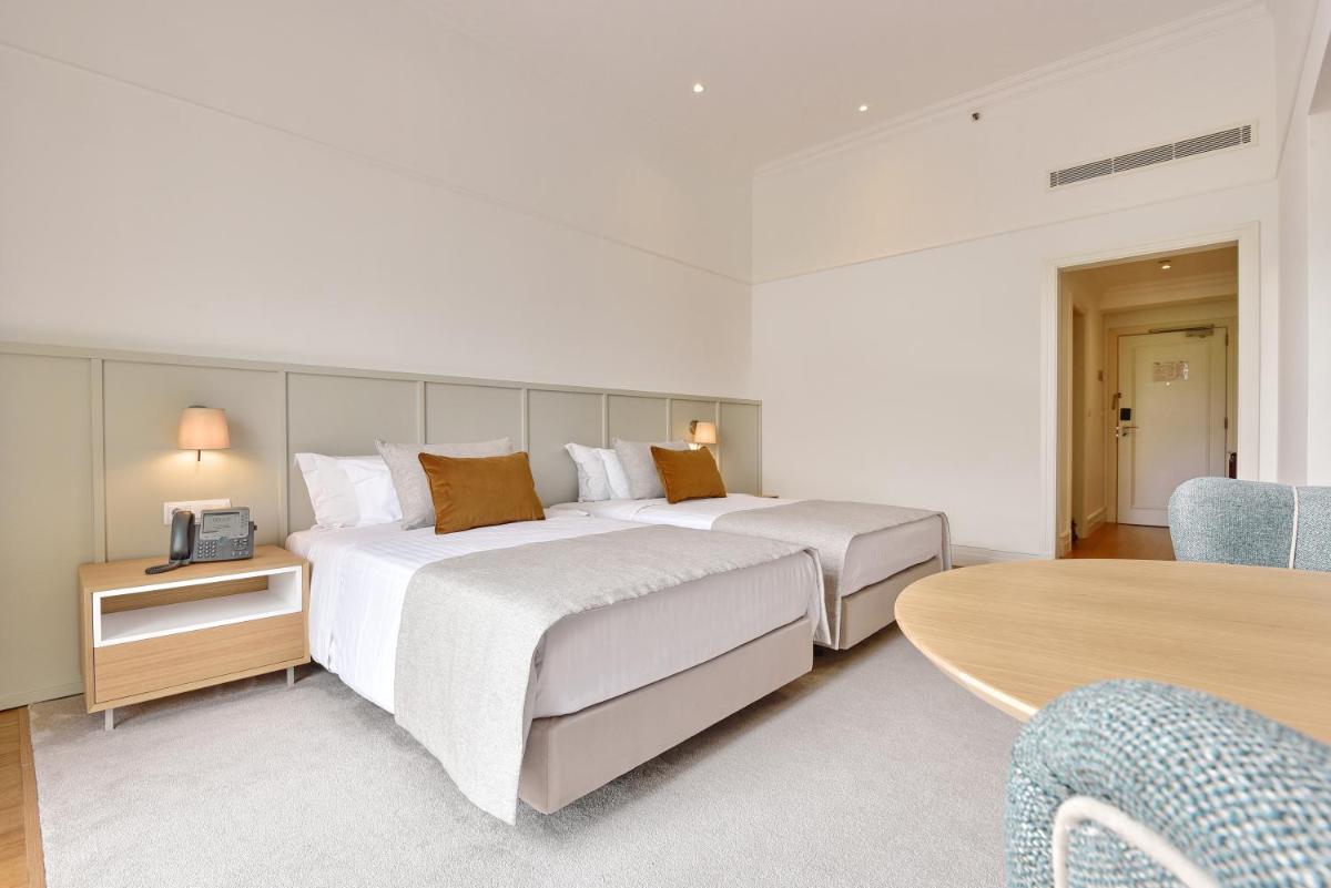 Uma cama ou camas num quarto em Dolce CampoReal Lisboa