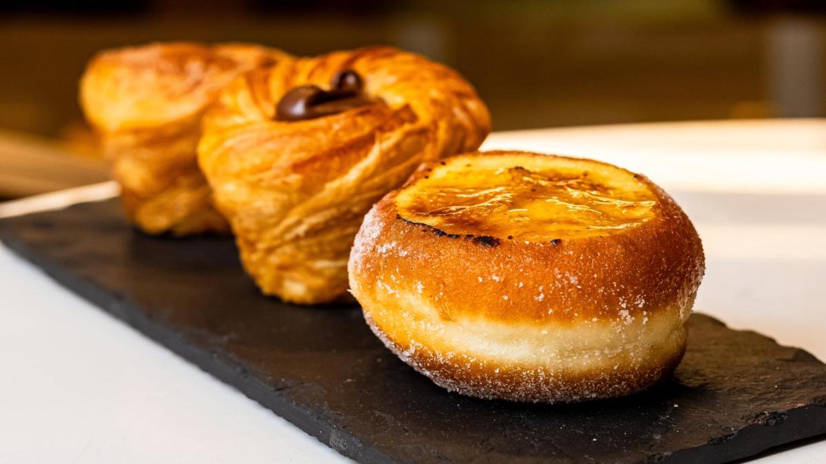three croissants sitting on a tray on a table at Crowne Plaza Today Gurugram by IHG in Gurgaon