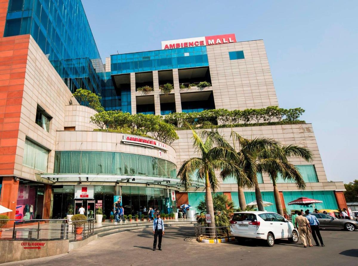 a large building with palm trees in front of it at Crowne Plaza Today Gurugram by IHG in Gurgaon