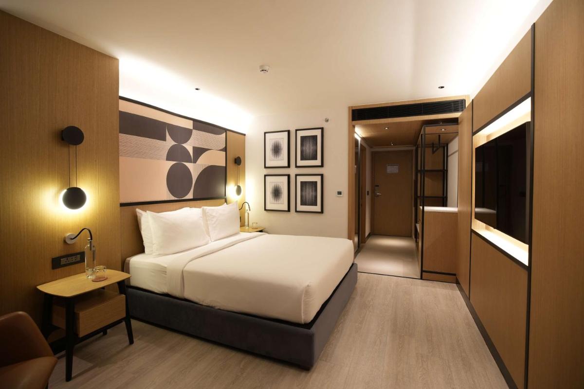 a hotel room with a bed and a small table at Parallel Hotel Udaipur, a member of Radisson Individuals in Udaipur