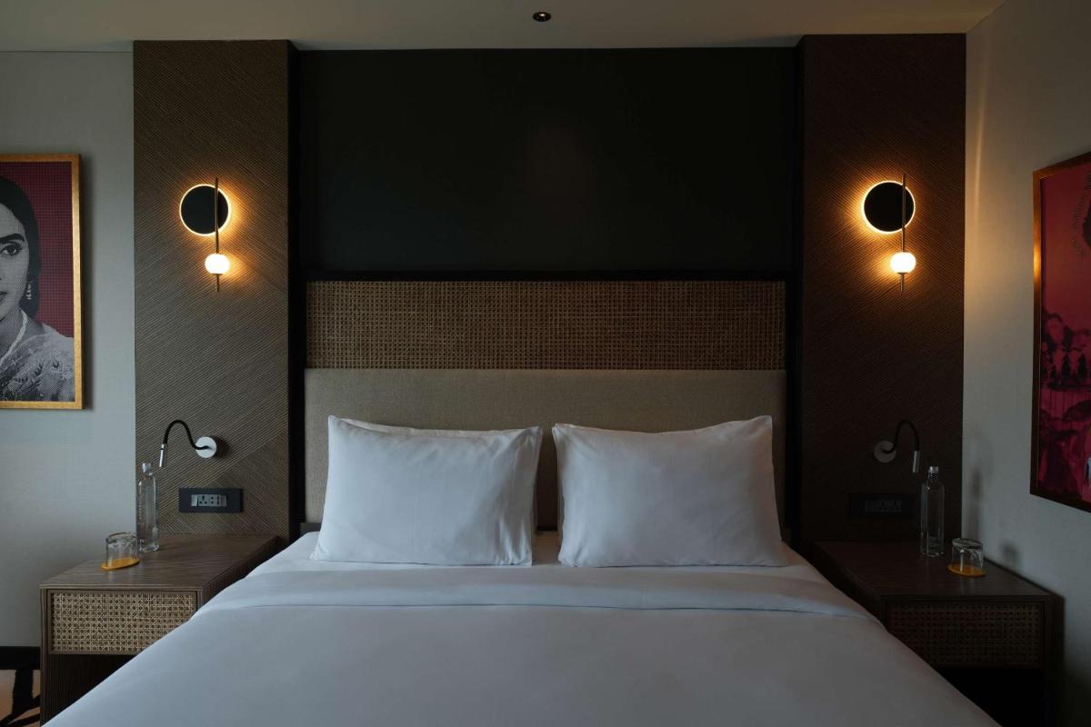 a bedroom with a large bed with two white pillows at Parallel Hotel Udaipur, a member of Radisson Individuals in Udaipur