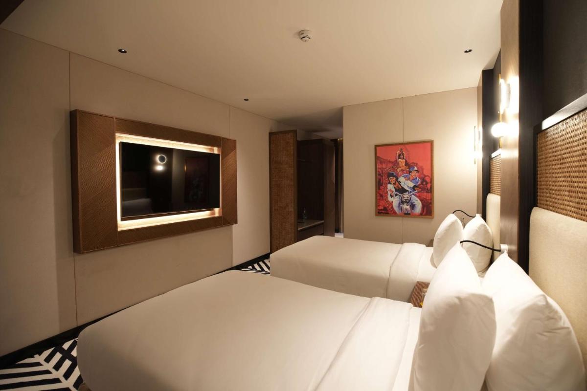 a hotel room with two beds and a television at Parallel Hotel Udaipur, a member of Radisson Individuals in Udaipur