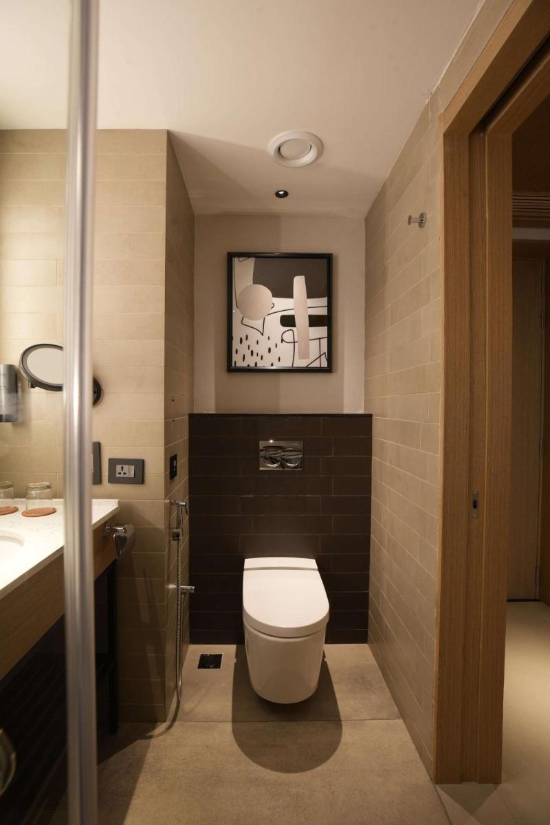 a bathroom with a toilet and a sink at Parallel Hotel Udaipur, a member of Radisson Individuals in Udaipur