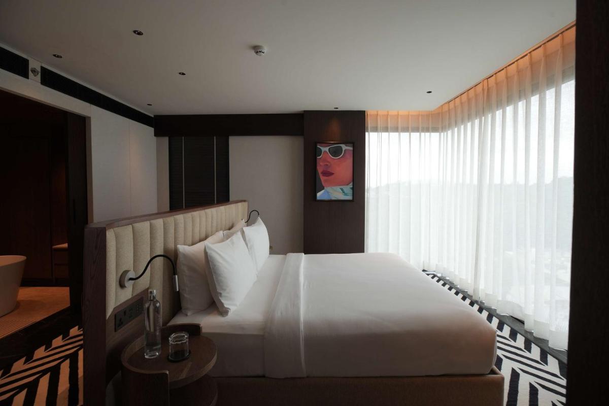 a bedroom with a large white bed and a window at Parallel Hotel Udaipur, a member of Radisson Individuals in Udaipur