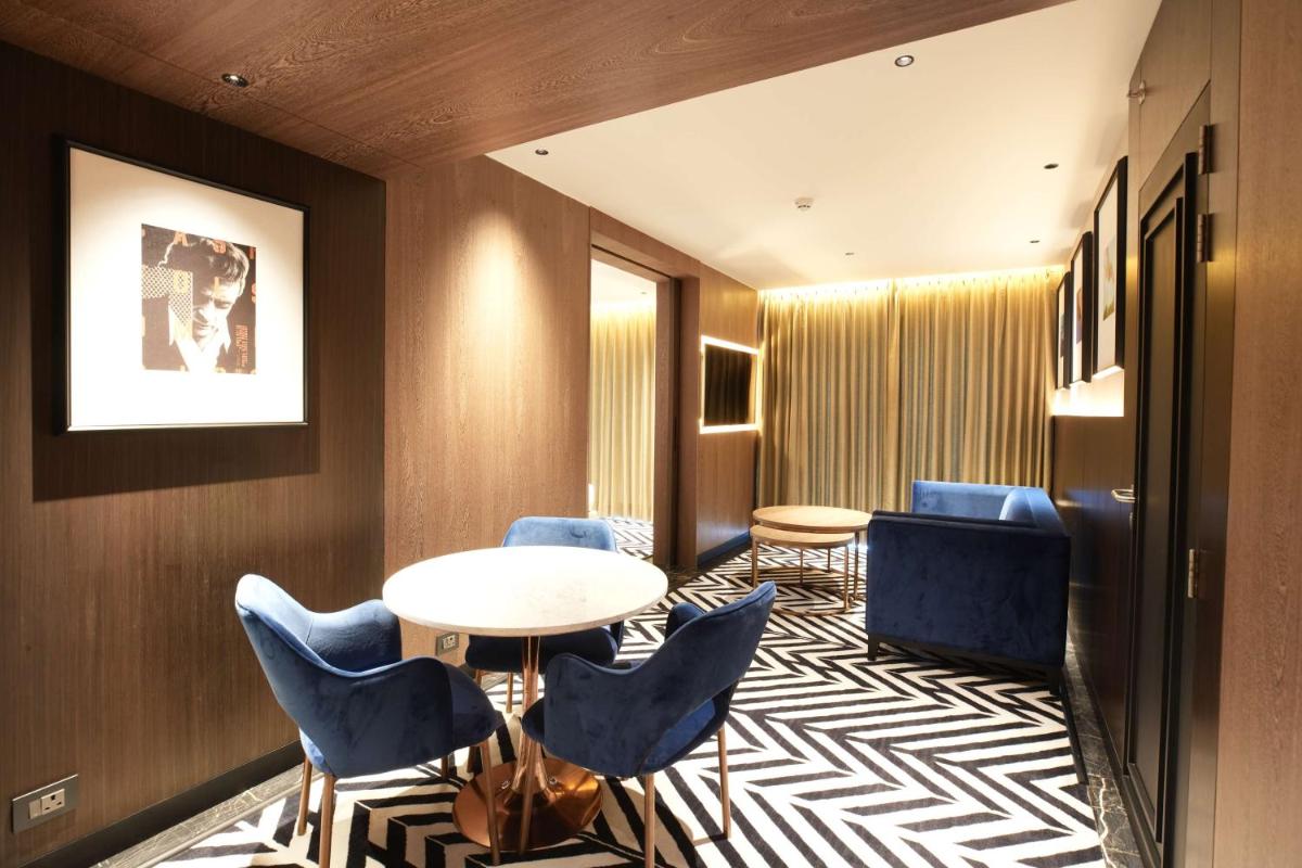 a hotel room with a table and chairs at Parallel Hotel Udaipur, a member of Radisson Individuals in Udaipur