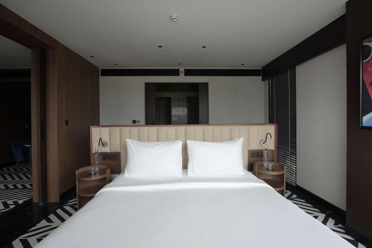 a large white bed with two pillows in a room at Parallel Hotel Udaipur, a member of Radisson Individuals in Udaipur