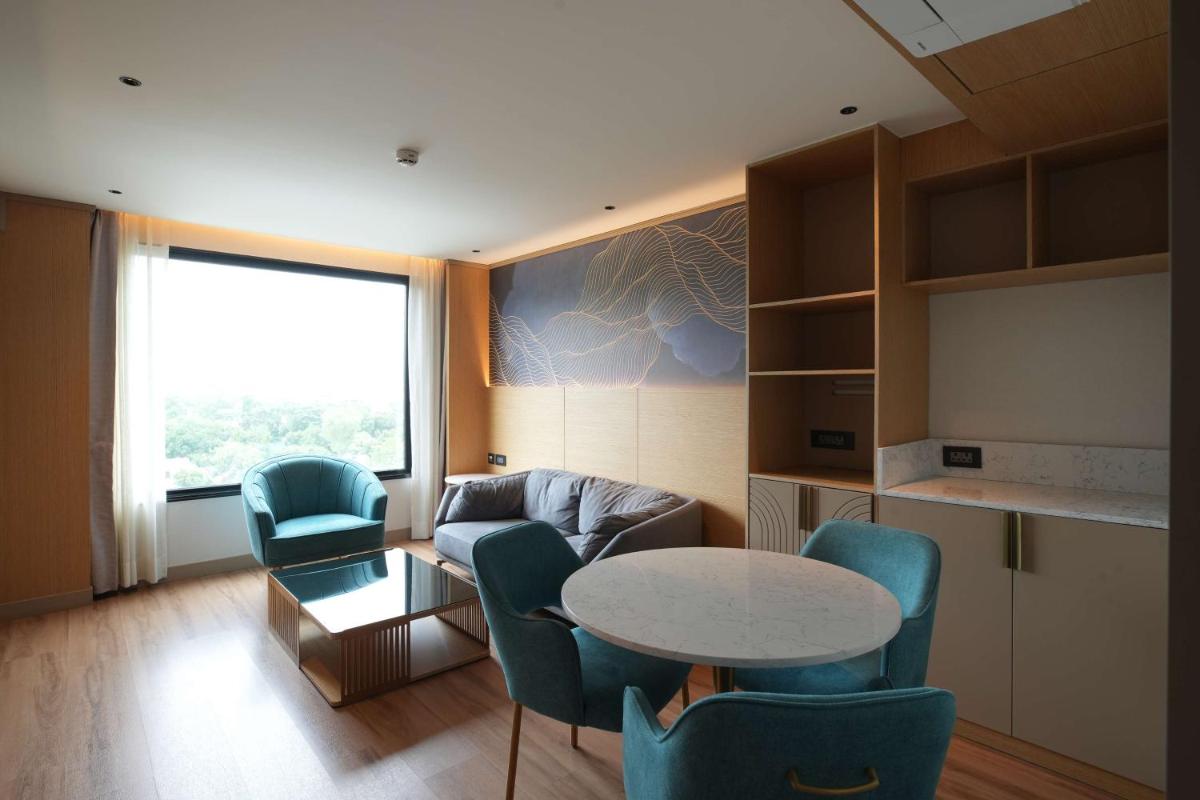 a living room with a table and chairs at Parallel Hotel Udaipur, a member of Radisson Individuals in Udaipur