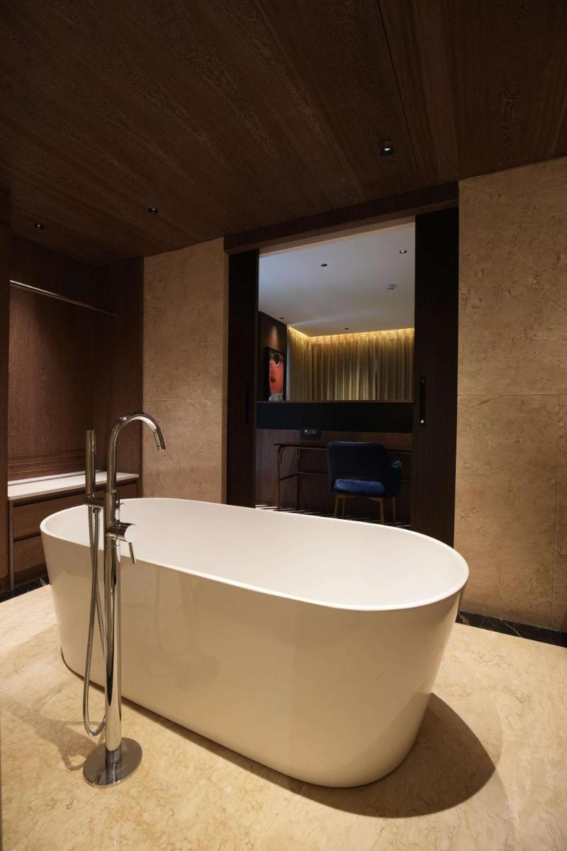 a large bath tub in a bathroom with a mirror at Parallel Hotel Udaipur, a member of Radisson Individuals in Udaipur