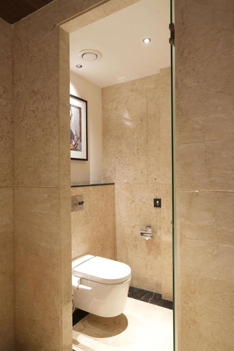 a bathroom with a toilet and a glass door at Parallel Hotel Udaipur, a member of Radisson Individuals in Udaipur