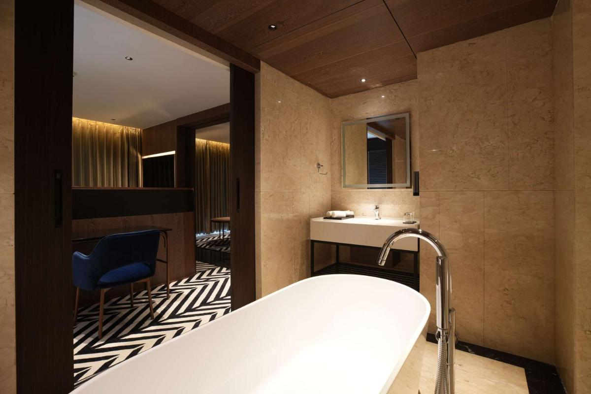 a bathroom with a tub and a sink at Parallel Hotel Udaipur, a member of Radisson Individuals in Udaipur