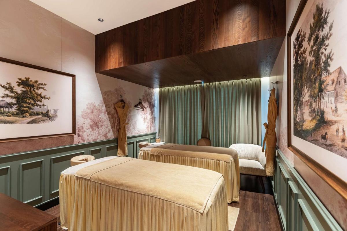 a treatment room with two beds and a window at Parallel Hotel Udaipur, a member of Radisson Individuals in Udaipur