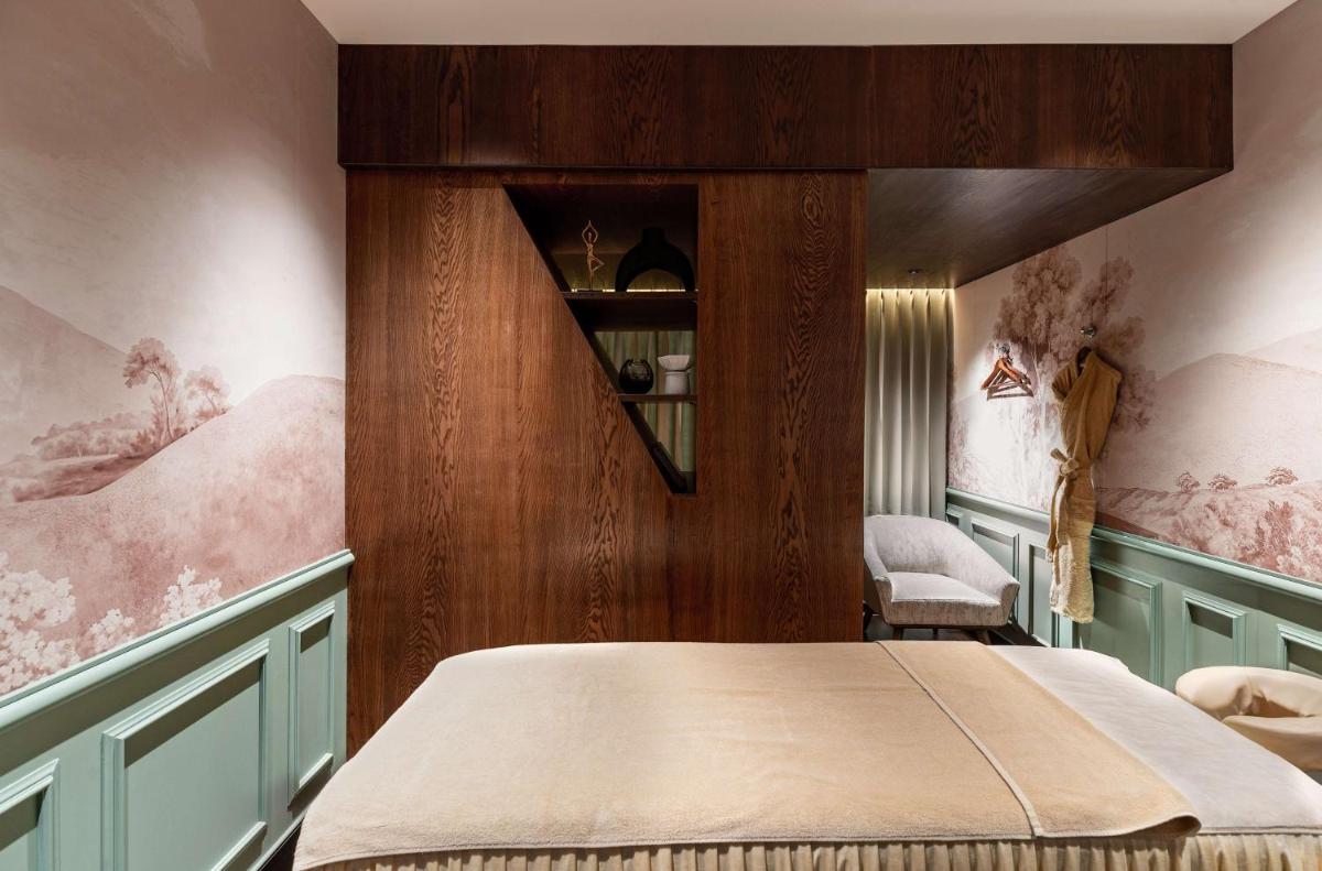 a bedroom with a bed and a chair in it at Parallel Hotel Udaipur, a member of Radisson Individuals in Udaipur