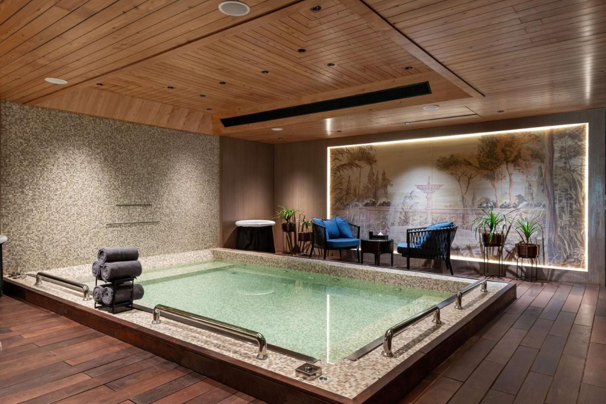 a pool in a room with a table and chairs at Parallel Hotel Udaipur, a member of Radisson Individuals in Udaipur