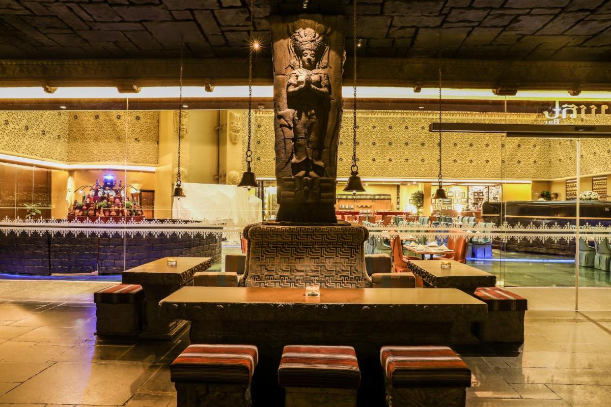 a large statue in the middle of a restaurant at Sterlings Mac Hotel in Bengaluru