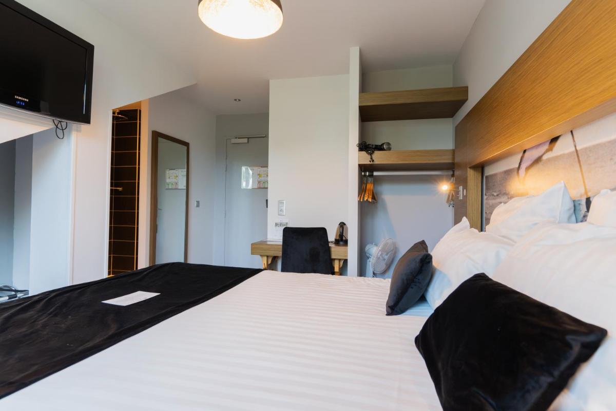 Un ou plusieurs lits dans un hébergement de l'établissement Best Western Hôtel Garden and Spa