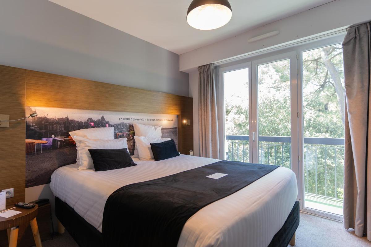 Un ou plusieurs lits dans un hébergement de l'établissement Best Western Hôtel Garden and Spa