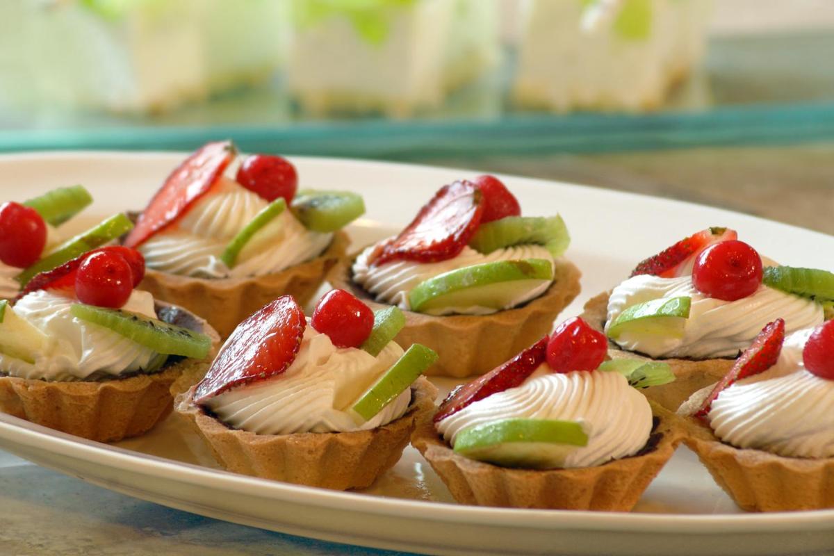 a plate of mini tarts with fruit on it at Fortune JP Palace, Mysore - Member ITC Hotels' Group in Mysore