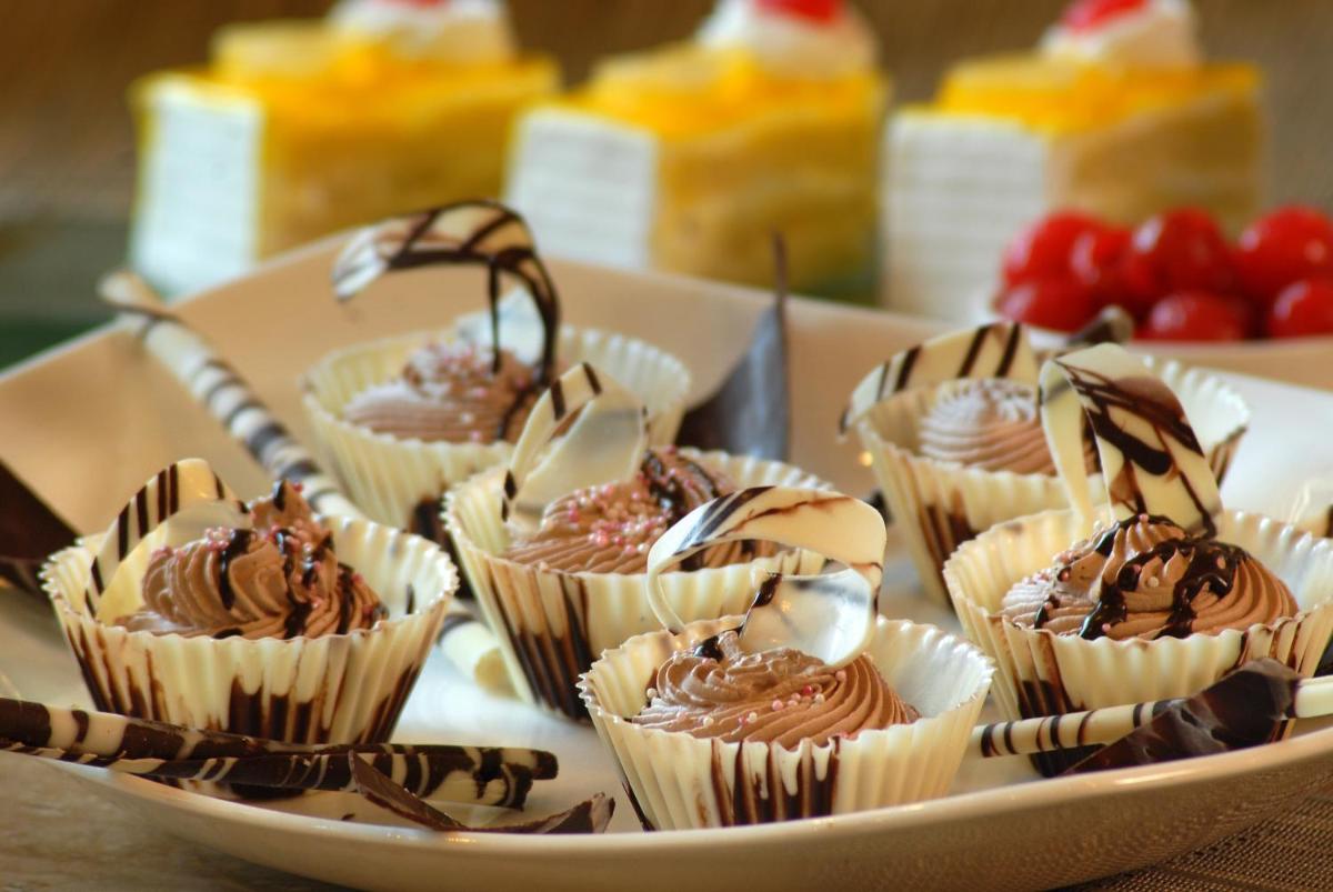 a tray of cupcakes with chocolate on top on a table at Fortune JP Palace, Mysore - Member ITC Hotels' Group in Mysore
