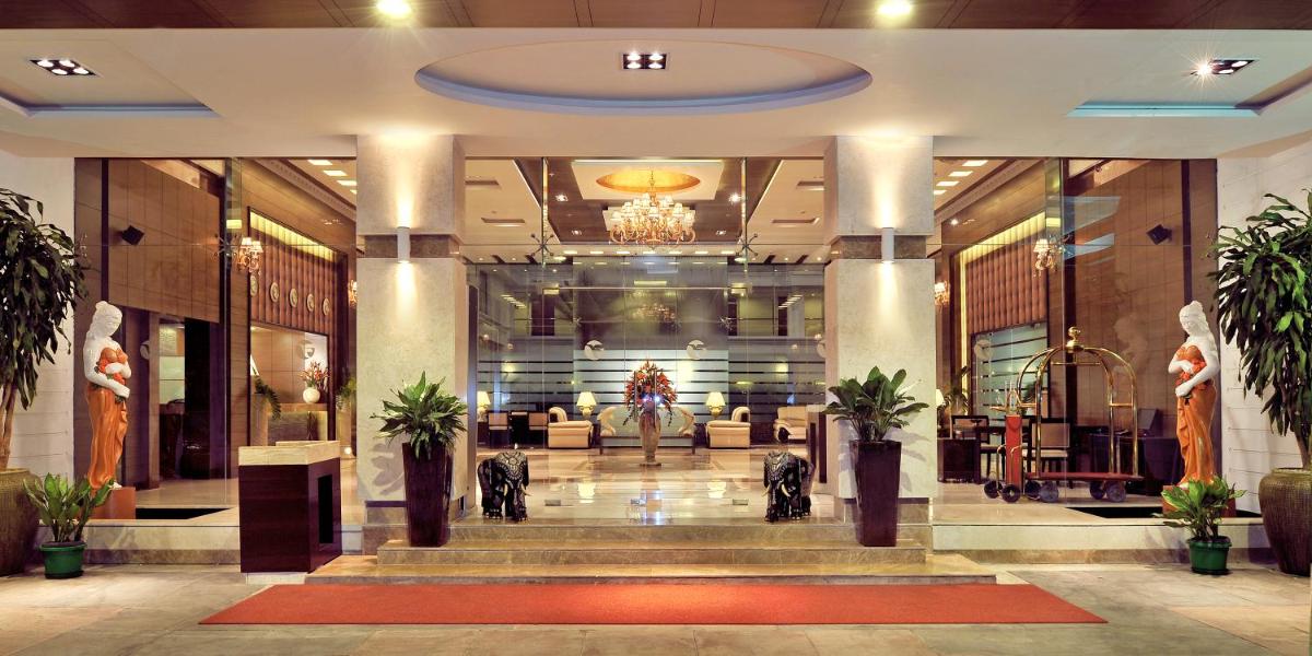 a lobby of a hotel with couches and plants at Fortune JP Palace, Mysore - Member ITC Hotels' Group in Mysore +43 photos