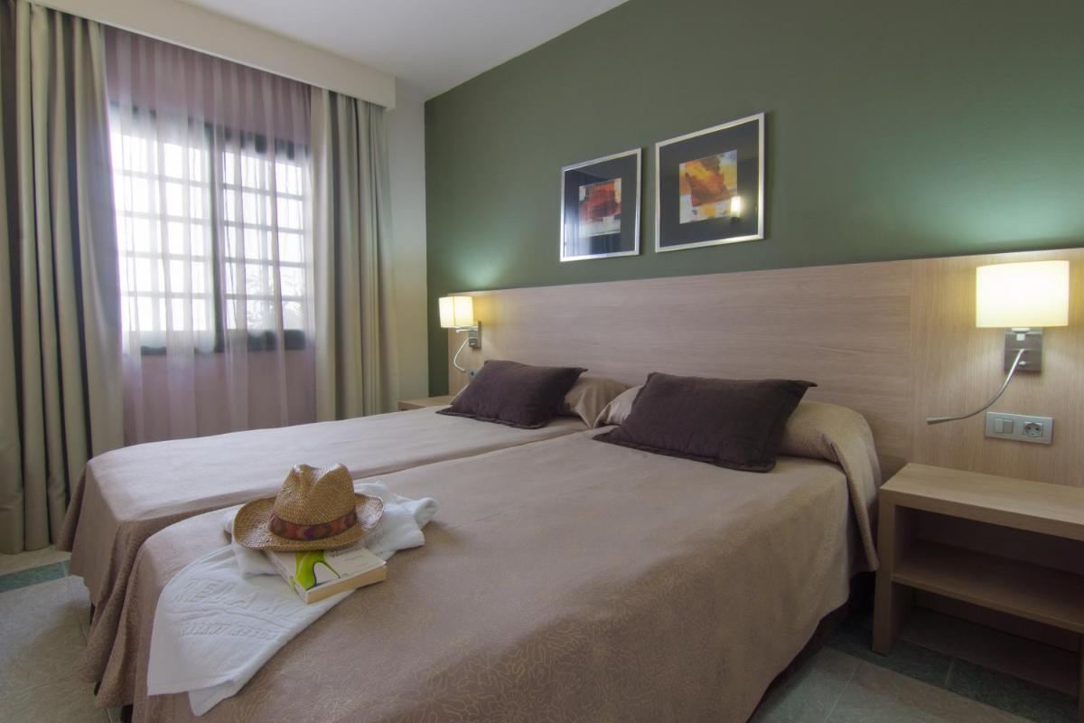 Cama o camas de una habitación en Relaxia Lanzasur Club - Aqualava Water Park