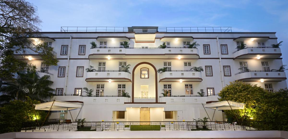 a large white building with tables in front of it at Ambassador, New Delhi - IHCL SeleQtions in New Delhi a large white building with tables in front of it at Ambassador, New Delhi - IHCL SeleQtions in New Delhi