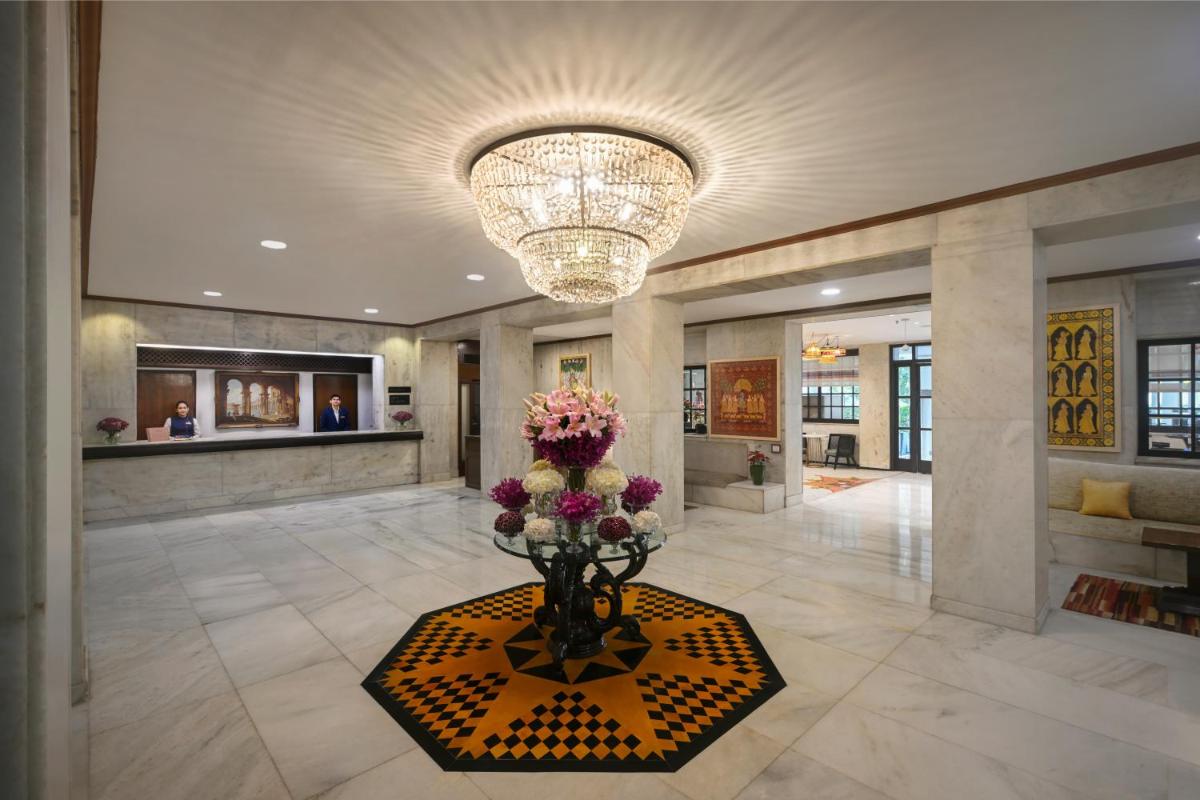 a lobby with a vase of flowers and a chandelier at Ambassador, New Delhi - IHCL SeleQtions in New Delhi a lobby with a vase of flowers and a chandelier at Ambassador, New Delhi - IHCL SeleQtions in New Delhi