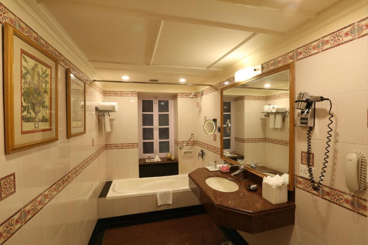 a bathroom with a sink and a bath tub at Ambassador, New Delhi - IHCL SeleQtions in New Delhi a bathroom with a sink and a bath tub at Ambassador, New Delhi - IHCL SeleQtions in New Delhi