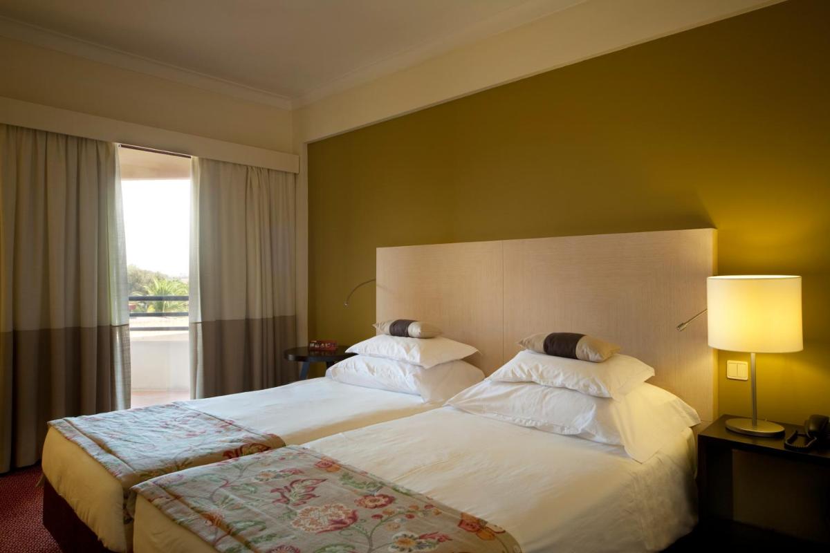 Uma cama ou camas num quarto em Evora Hotel