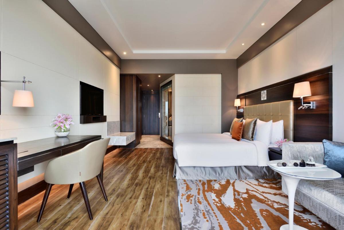 a hotel room with a bed and a desk at Taj Agra in Agra